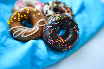 Delicious colorful donuts with different flavors on the background