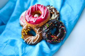 Delicious colorful donuts with different flavors on the background