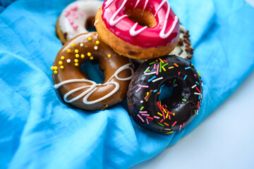 Delicious colorful donuts with different flavors on the background