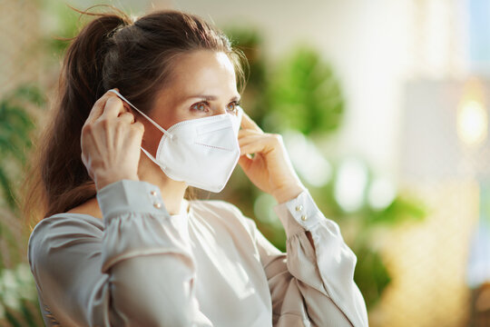 trendy woman in grey blouse wearing ffp2 mask