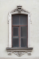 Fototapeta na wymiar Windows on old city facades, with decorative elements