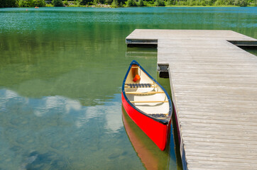 Reflection in water of mountain lakes and boats. Alta lake in Whistler, Vancouver, Canada. Beauty world.