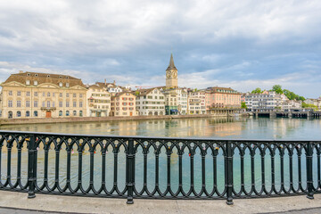 Beautiful view of historic city center of Zurich with famous Fraumunster Church and Munsterbucke crossing river Limmat Canton of Zurich, Switzerland
