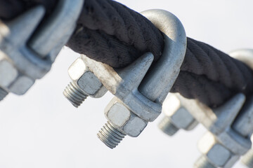 The U-Bolts are close up. The fastening of steel wire ropes with safety locking U-Bolts.