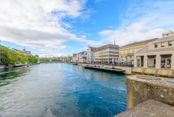 Fototapeta premium Beautiful view of historic city center of Zurich with river Limmat on a sunny day with blue sky and clouds in summer, Canton of Zurich, Switzerland.