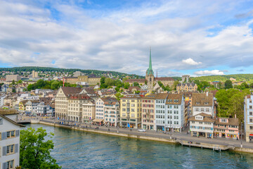 Fototapeta na wymiar Beautiful view of historic city center of Zurich with river Limmat on a sunny day with blue sky and clouds in summer, Canton of Zurich, Switzerland.