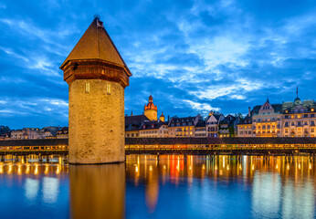 Night view towards Chapel Bridge (Kapellbruecke) together with the octagonal tall tower (Wasserturm) it is one of the Lucerne's most famous tourists attraction