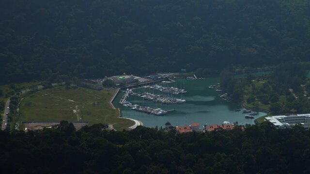 zoom of thai beach and harbor with forest background.