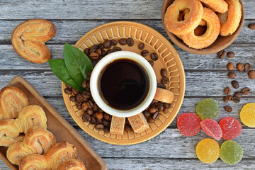 Fresh aromatic coffee and crispy cookies on a wooden background.