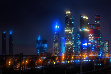 Moscow-city at night in the rain in the fog and at low clouds. High quality photo