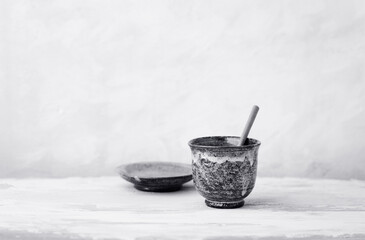 Traditional, handcrafted ceramic on bright wooden background. Soft focus. Copy space.	