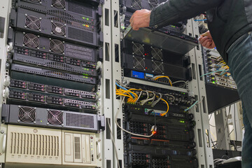 Installing a new setver in the data center rack. Replacement of equipment in the server room. Data...