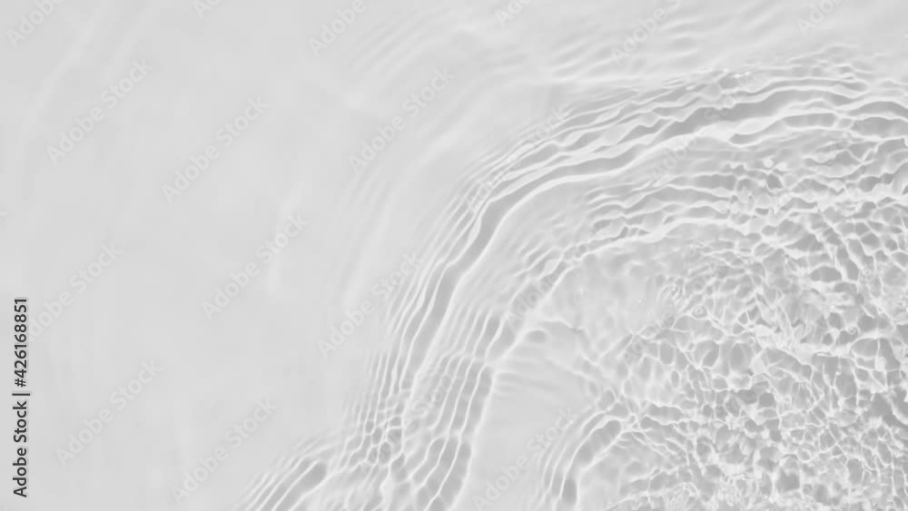 Poster up close, top view, slow motion various waves of the water surface hitting the sun's rays, making th
