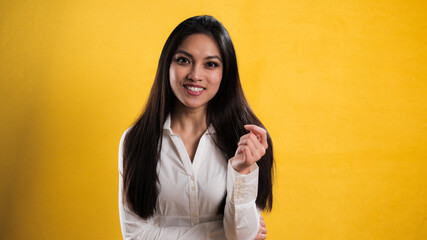 Self-confident satisfied young woman against neutral background - studio photography