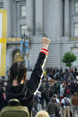 Vertical shot of a female with a clenched fist during the Black Lives Matter protest - obrazy, fototapety, plakaty
