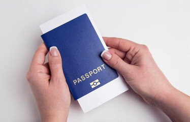 Blue passport in female hands. Human immunity passport on a white background.