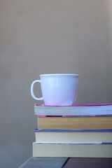 Stack of books and cup of tea or coffee. Selective focus.