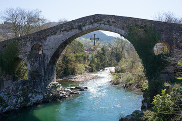 Fototapeta na wymiar Beautiful bridge over Sella river at Cangas de Onis, Asturias. Roman bridge, sunny day and no people
