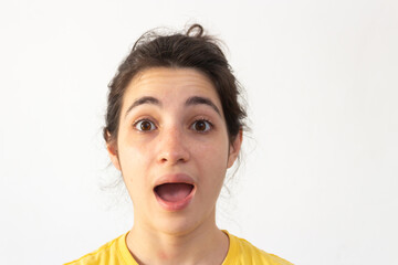 Woman with yellow t-shirt on white background surprised