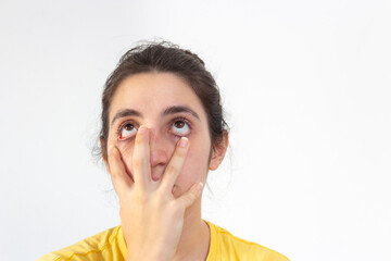 Woman with yellow t-shirt on white background disgusted