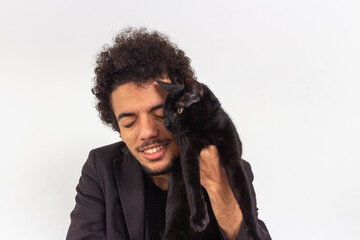 Black man with black t-shirt and blazer on white background with black cat