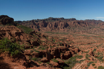 Travel. Desert landscape. Panorama view of the red desert, sandstone, cliffs and rocky mountains under a blue sky in Sierra de las Quijadas national park, San Luis, Argentina. 