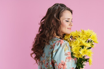 relaxed modern woman with long wavy brunette hair on pink