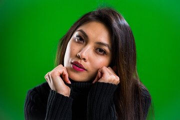 Young pretty woman posing for the camera in a studio - studio photography