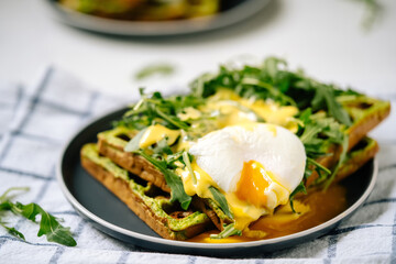 Eggs Benedict on Waffles with Arugula Salad Leaves