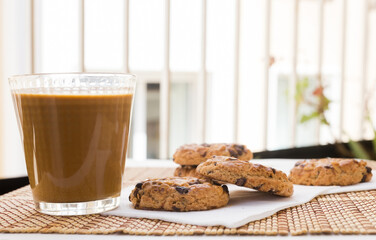 cookies with chocolate and hazelnuts and coffee with milk lie on