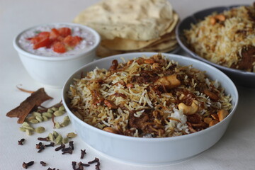 Mutton Biryani. A dish cooked with spices layered between mildly spiced ghee rice with a generous sprinkle of caramelized onions and Mutton marinated in yogurt