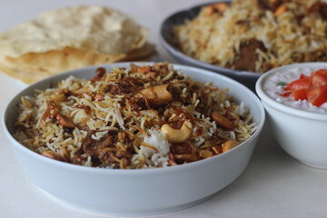 Mutton Biryani. A dish cooked with spices layered between mildly spiced ghee rice with a generous sprinkle of caramelized onions and Mutton marinated in yogurt