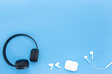 Earphones in head black and white headphones, wireless, and white dial headphone isolated on blue background