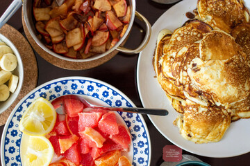 breakfast, brunch pancakes, homemade apple jam, bananas and fruits. Top view.