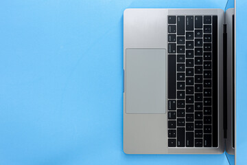 Top view Laptop with copy space isolated on blue background