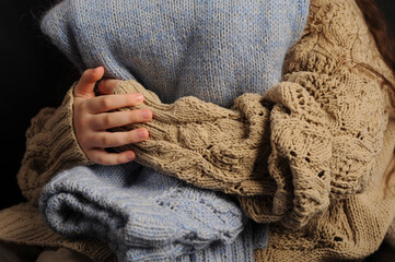 Fototapeta na wymiar girl holding a warm knitted sweater
