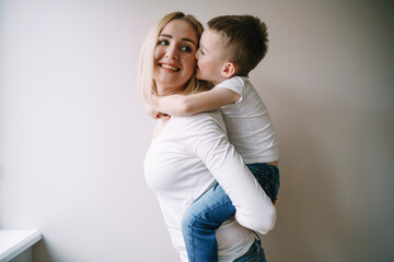 mom with little son in the white kitchen