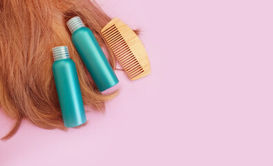 Fototapeta na wymiar shampoo, wooden comb on a colored background