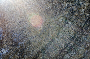 gray marble background with sunlight and lens glare