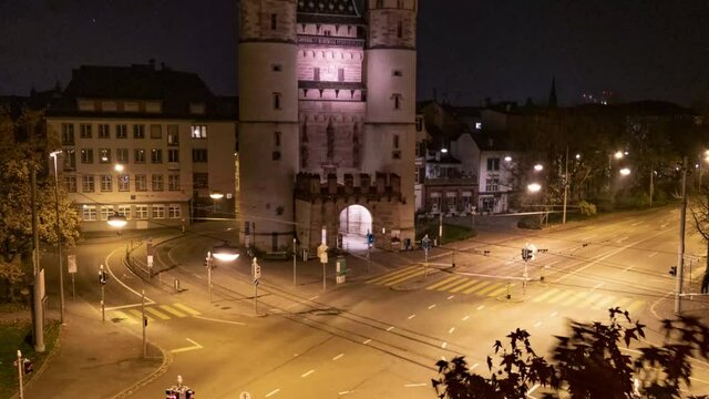 Timelapse at night from Spalentor. Cars and trams cross the intersection in Basel, Switzerland. Copy space