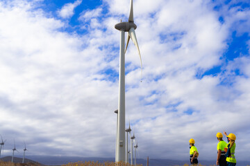 One engineer and skilled workers discussed the plan for the maintenance of wind turbines. Renewable...