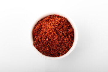 Korean hot pepper flakes. Pepper flakes in white bowl, on white background