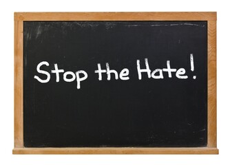 Obraz premium Stop the Hate written in white chalk on a black chalkboard isolated on white