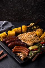 Grilled sausages, meat, and vegetables.