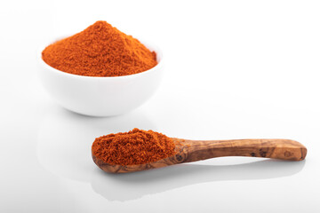 Red hot pepper powder. Pepper powder in white bowl, on white background