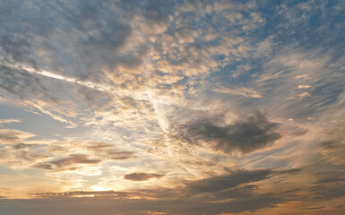 Morning blue orange sky, sun shining through clouds