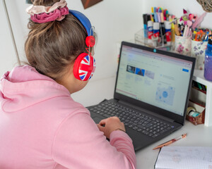Fototapeta Dziecko uczy się przy biurku w swoim pokoju , lekcje online , nauczanie zdalne podczas pandemii koronawirusa obraz