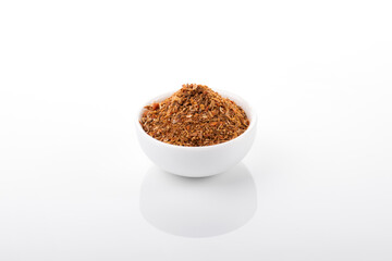 Ras el hanout moroccan spice. Ras el hanout in white bowl, on white background. Moroccan spice