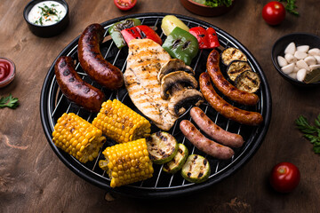 Grilled sausages, meat, and vegetables.
