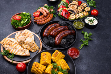 Grilled sausages, meat, and vegetables.